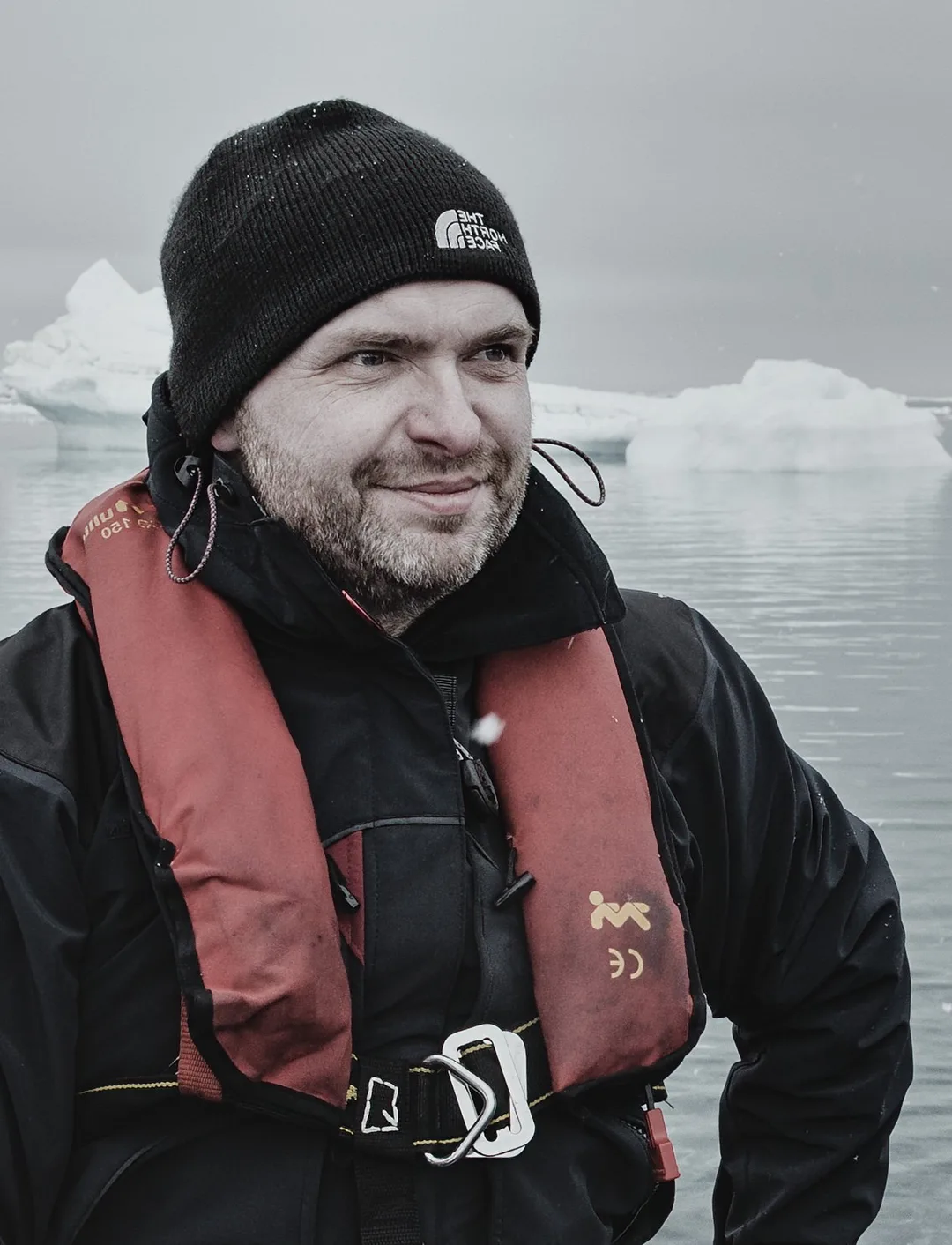 Michael Ahlen in the Arctic, aboard a zodiac among icebergs